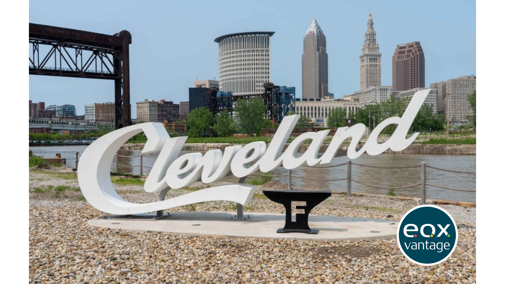 Large Cleveland script sign with the Foundry logo in front of the Cuyahoga river and Cleveland skyline